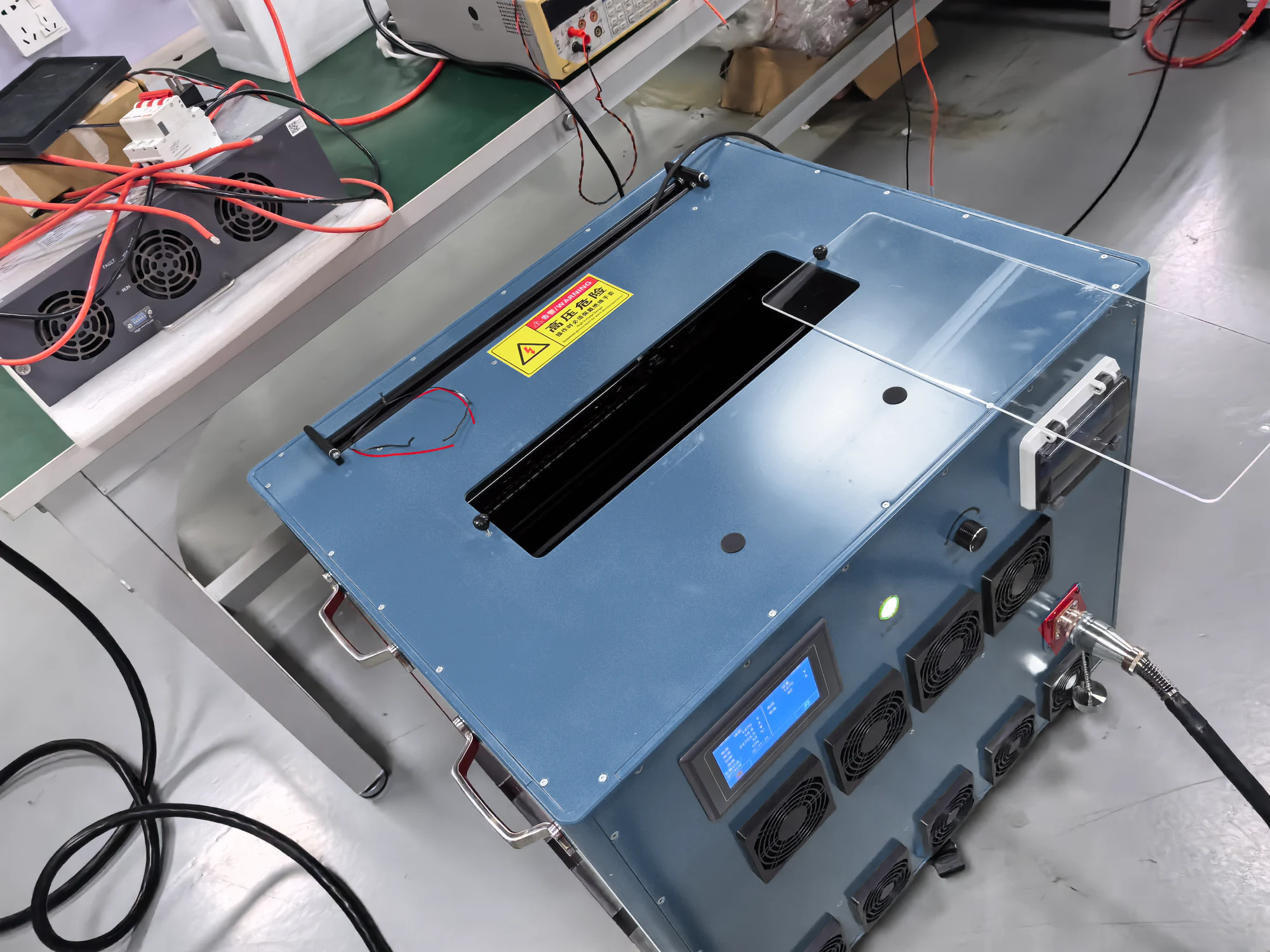 Ground power enclosure and connected cables on a factory workbench