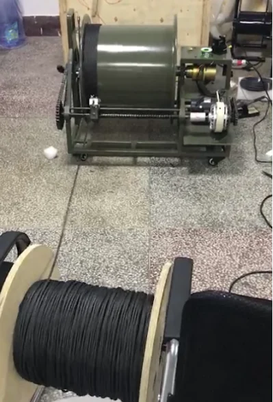 High-voltage tether cable reel for a heavy-lift firefighting drone power system.