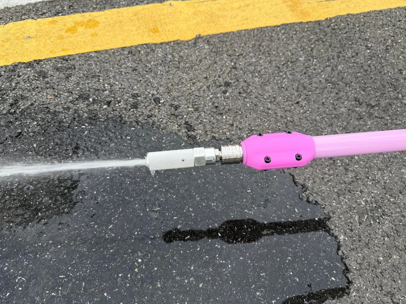 Dual-mode drone cleaning nozzle undergoing a clean-water spray test.